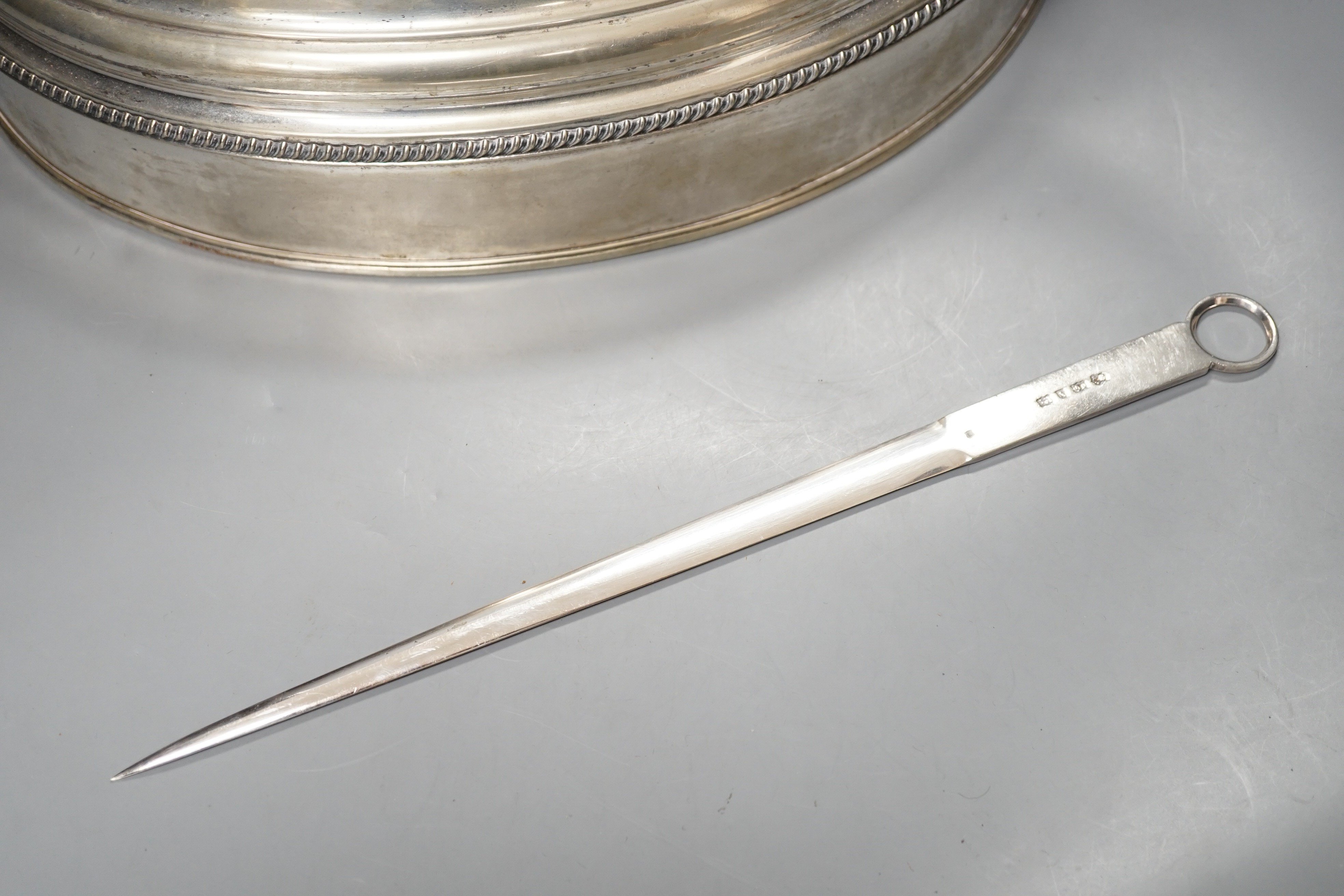 A silver plated cloche / meat cover and a plated meat skewer